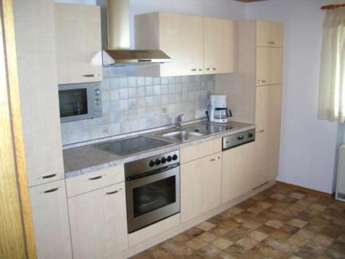 a kitchen with a sink and a stove top oven at Ferienwohnung Seidl in Waffenbrunn