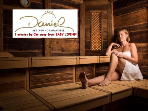 a woman sitting on the ledge of a sauna at Easy Living Apartment Ötztal in Sautens