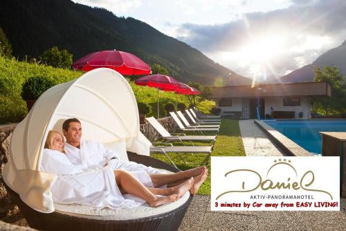 a man and a woman laying in a bed next to a pool at Easy Living Apartment Ötztal in Sautens