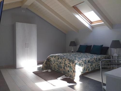 a bedroom with a bed with blue pillows and a window at Room73 in Paestum