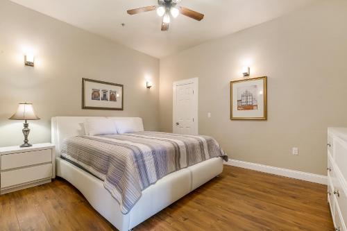 Schlafzimmer mit einem Bett und einem Deckenventilator in der Unterkunft St Charles Ave Urban Retreat with Luxury Amenities in New Orleans