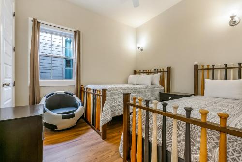 a room with two beds and a crib in it at Stunning Penthouse in the Heart of the City in New Orleans