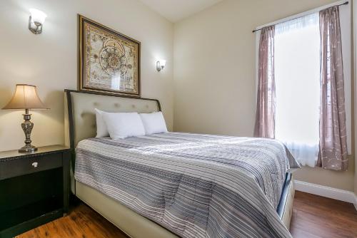 a bedroom with a bed and a window at Stunning Penthouse in the Heart of the City in New Orleans