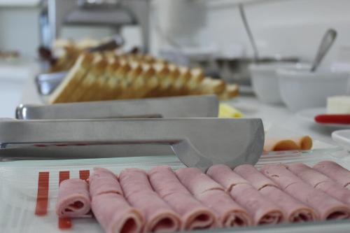 a bunch of hot dogs are being prepared in a kitchen at Terra do Chimarrão Hotel in Venâncio Aires