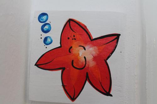 a painting of a red star on a wall at B&B Villa Luna in Bayahibe