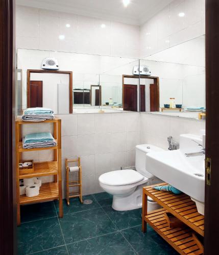 a bathroom with a toilet and a sink at Anjos 44 Lisbon Apartments in Lisbon