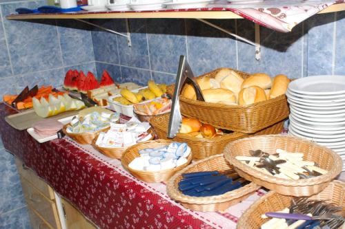 a buffet with baskets of bread and other foods at Las Vegas Hotel in Sao Paulo