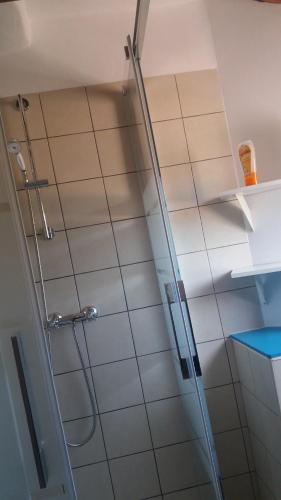a shower in a bathroom with white tiles at Corral De La Solana in Molinos