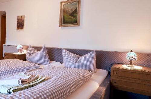 two beds sitting next to each other in a room at Pension Adler in Sonthofen
