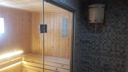 a sauna with a glass shower in a room at hotel "Riverside Mestia" in Mestia