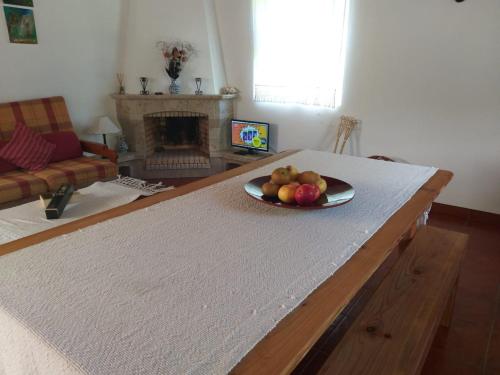 a bowl of fruit on a table in a living room at Azores Hibiscus House - Mountain and Sea in São Roque do Pico