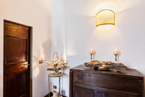 a room with a wooden dresser with a light on it at Fiesole's cozy Apartment 1 in Fiesole