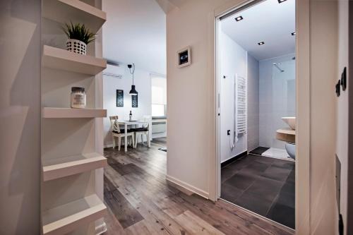 a hallway with a mirror and a dining room at Studio Biritin in Rovinj