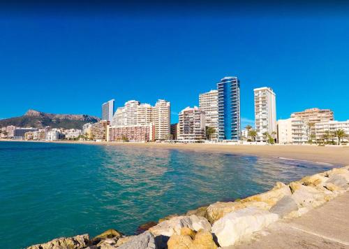 a beach in front of a city with tall buildings at Apartment APOLO XIV in Calpe