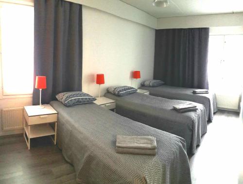 A bed or beds in a room at Hamina Orange Apartments Ilves