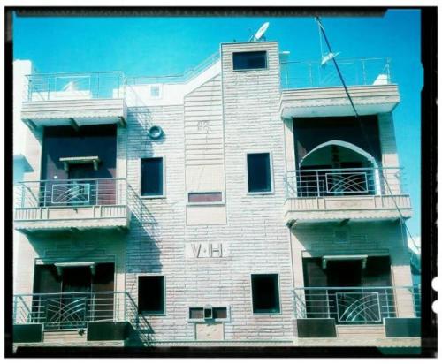a tall building with balconies on the side of it at Vidhya Haveli in Pushkar