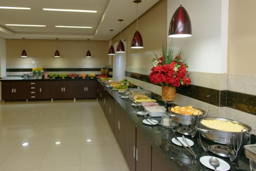 a buffet line of food in a hotel cafeteria at Hotel São Bento in Marabá