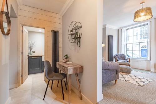a room with a desk and a bedroom with a bed at King Street Apartment in Norwich