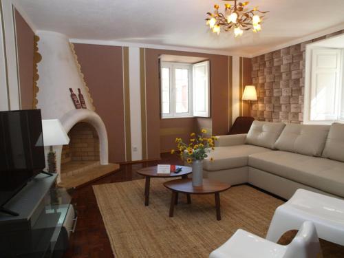 a living room with a couch and a tv at HENRI'S APARTMENTS - City Centre in Lagos