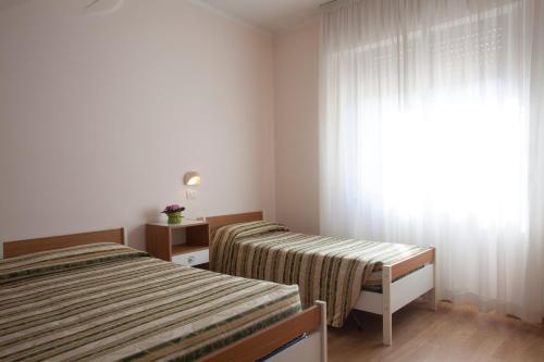 Postel nebo postele na pokoji v ubytování Hotel Cecco