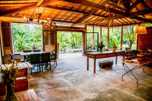 a large living room with a table and chairs at Vale da Vacaria in Serra do Cipo