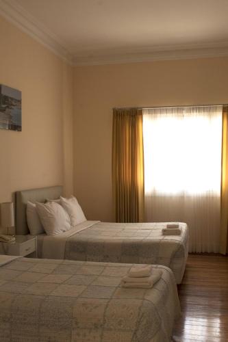 a hotel room with two beds and a window at Los Andes Bed & Breakfast in Arequipa