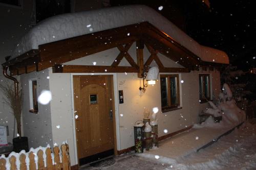 a small house covered in snow at night at Haus Zegg in Nauders