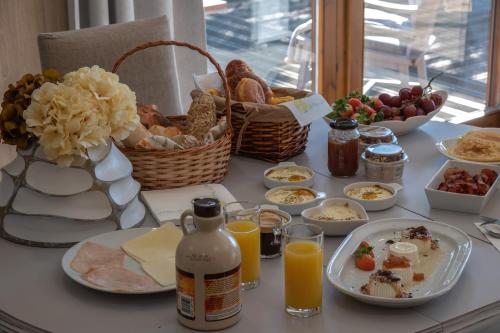 a breakfast table with breakfast foods and orange juice at Quintinha do Periqueiro in Castelo do Neiva