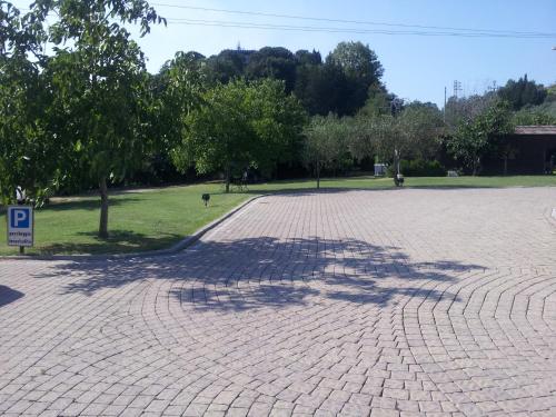 a shadow of a tree on a brick road at Luconi Affittacamere in Iesi