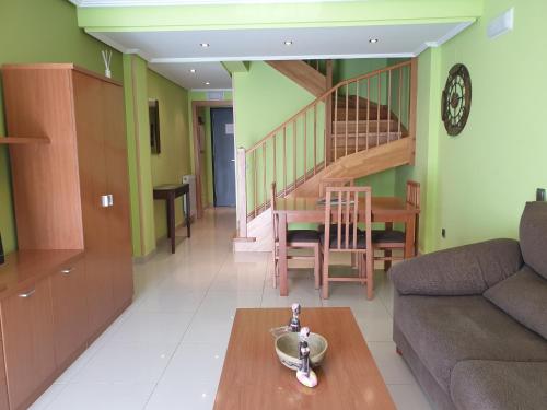 a living room with a couch and a table at Apartamentos Monte Hernanz in Riaza