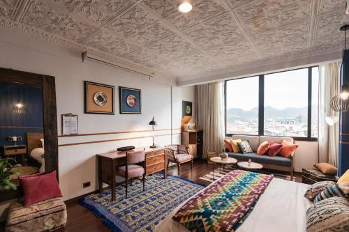 a hotel room with a bed and a desk at Selina Cuenca in Cuenca