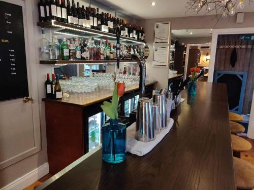 a bar with a counter with bottles and glasses at The Baytree Restaurant & Guesthouse in Carlingford