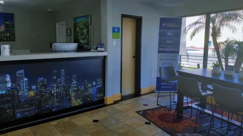 a bar in an office with a view of a city at Sunset West Hotel, SureStay Collection By Best Western in Los Angeles