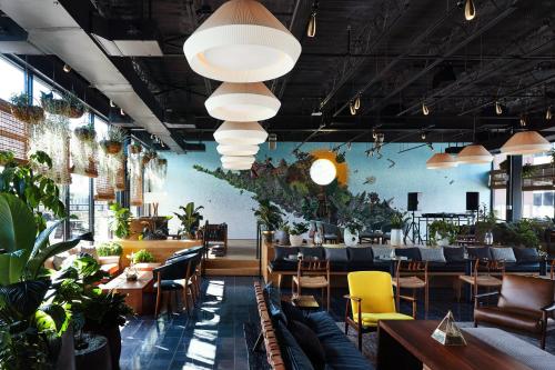 a restaurant with tables and chairs and potted plants at Eaton DC in Washington