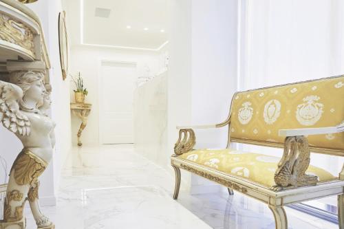 a room with a chair and a statue in it at Palazzo Marletta Luxury House Hotel in Catania