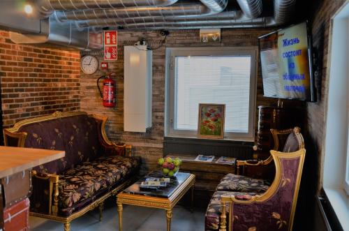 a living room with a couch and a table at Loft Family Hotel in Imatra