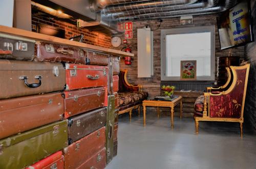 a room filled with lots of old trunks at Loft Family Hotel in Imatra