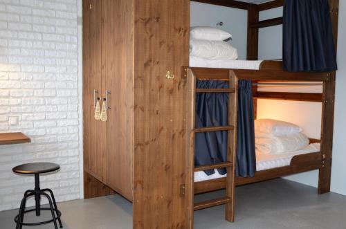 a couple of bunk beds in a room with a stool at Loft Family Hotel in Imatra