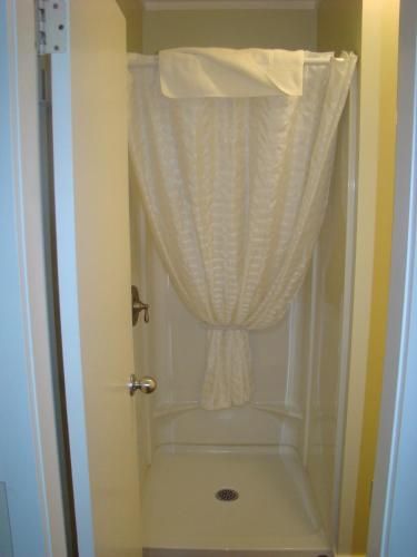 a bathroom with a shower with a curtain at Paddock Inn in Coleman