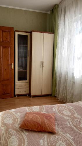 a bedroom with a bed and a closet and a door at Сонячна in Truskavets