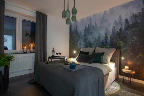 a bedroom with a bed with a large painting on the wall at Apartamenty Cisza - Ustrzyki Dolne noclegi - Bieszczady noclegi in Ustrzyki Dolne
