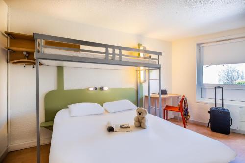 a bedroom with a bunk bed with a teddy bear on it at ibis budget Limoges Centre Gare in Limoges