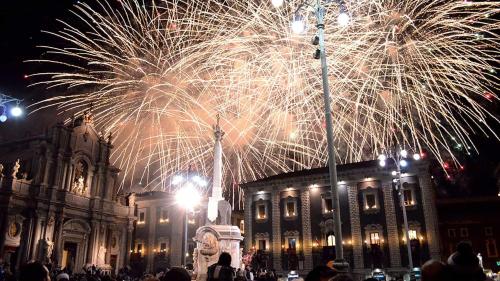 a group of people standing in front of a building with fireworks at Affitto breve Spider-man house in Catania