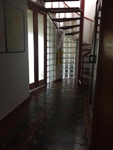 an empty hallway with a staircase in a building at El Romeron Casa de Campo in San Francisco