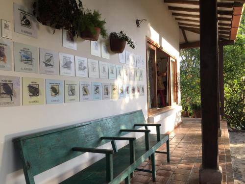 a bench in front of a building with pictures on the wall at El Romeron Casa de Campo in San Francisco