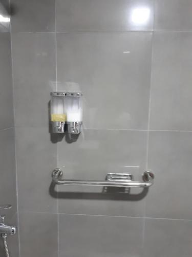 a bathroom with a soap dispenser on a wall at Perito Moreno - 3ro C in Puerto Iguazú