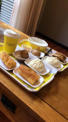 a tray of food on a table with pastries on it at Chongqing Ouranjian Lake View Guesthouse in Chongqing