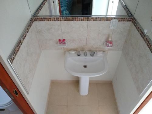 a bathroom with a sink and a toilet at JUANA II in Villa Elisa