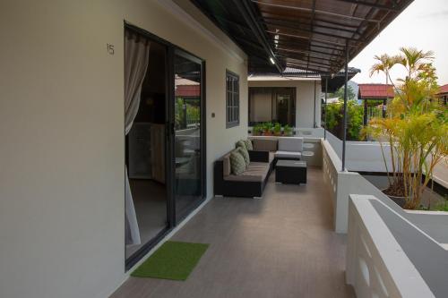 an outdoor patio with a couch and chairs on a house at Aussieland Bungalows in Lamai