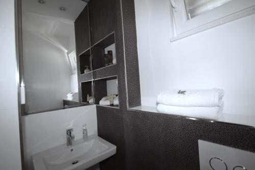 a bathroom with a sink and a mirror at Villa Lavanda Deluxe in Rogoznica